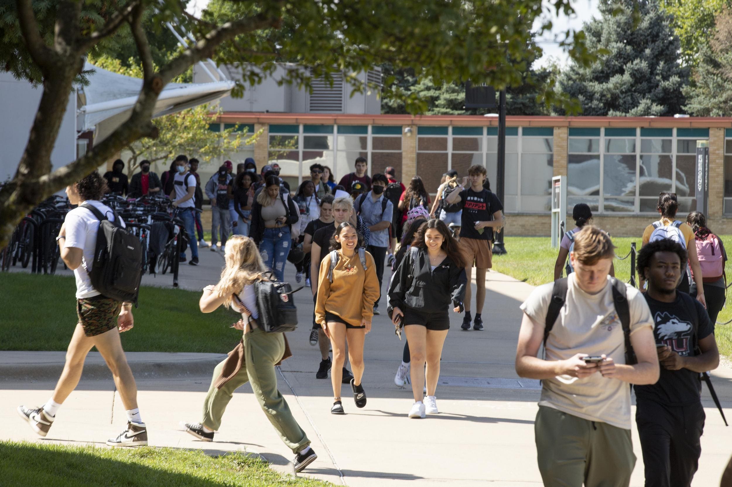 NIU students walking on campus during a beautiful summer day