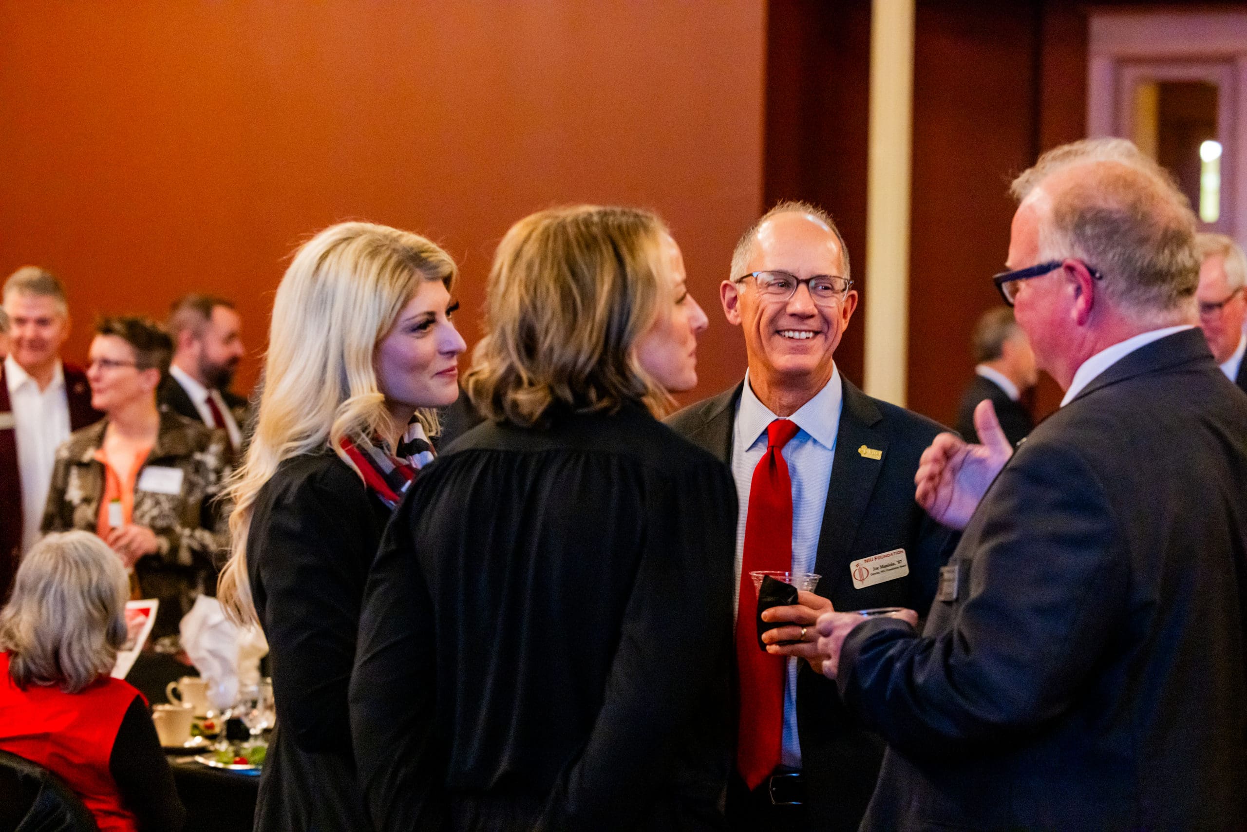 Group of people talking at a semi-formal gathering
